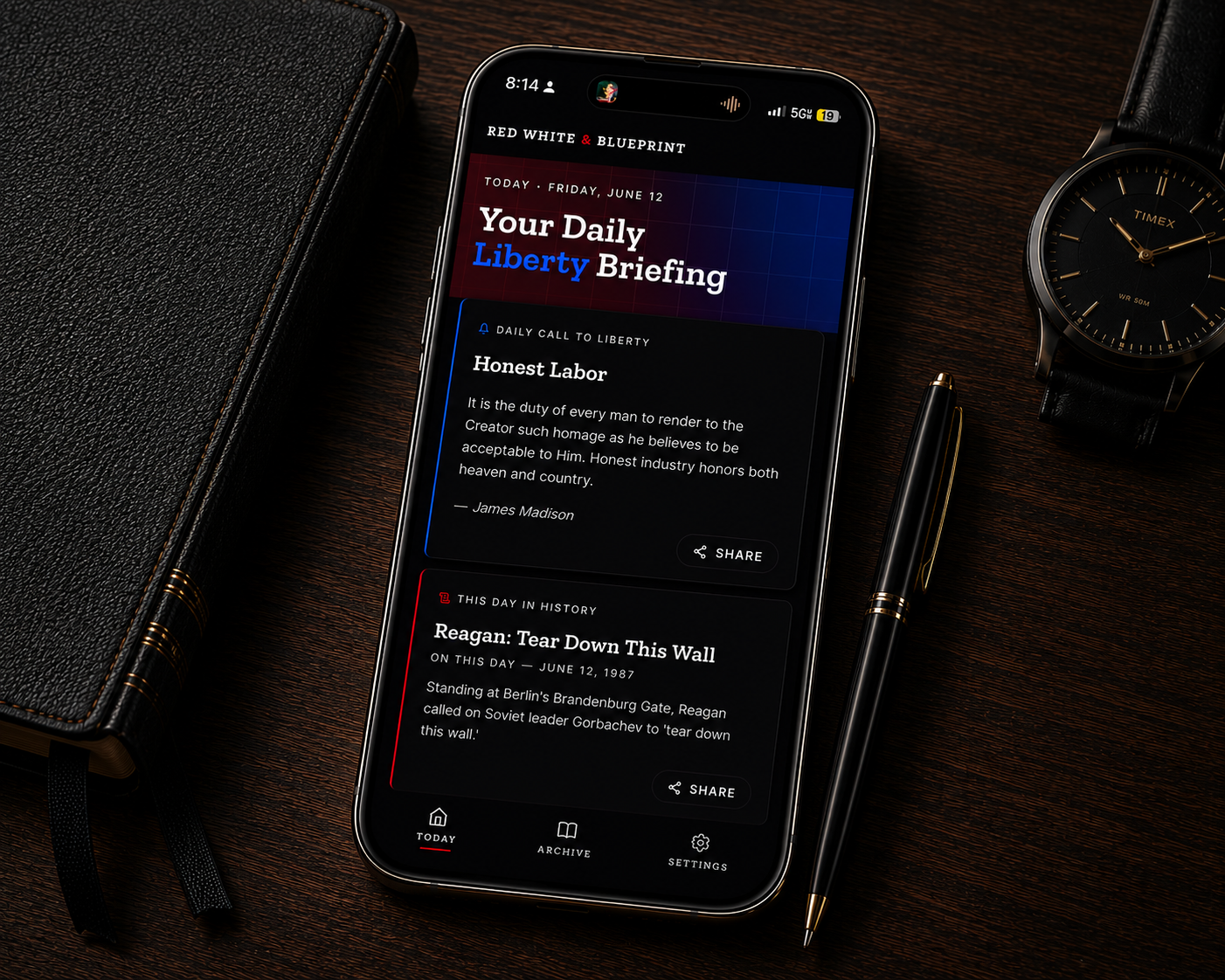 The Blueprint App — Daily Liberty Briefing shown on iPhone, on a leather-bound journal beside a Timex watch
