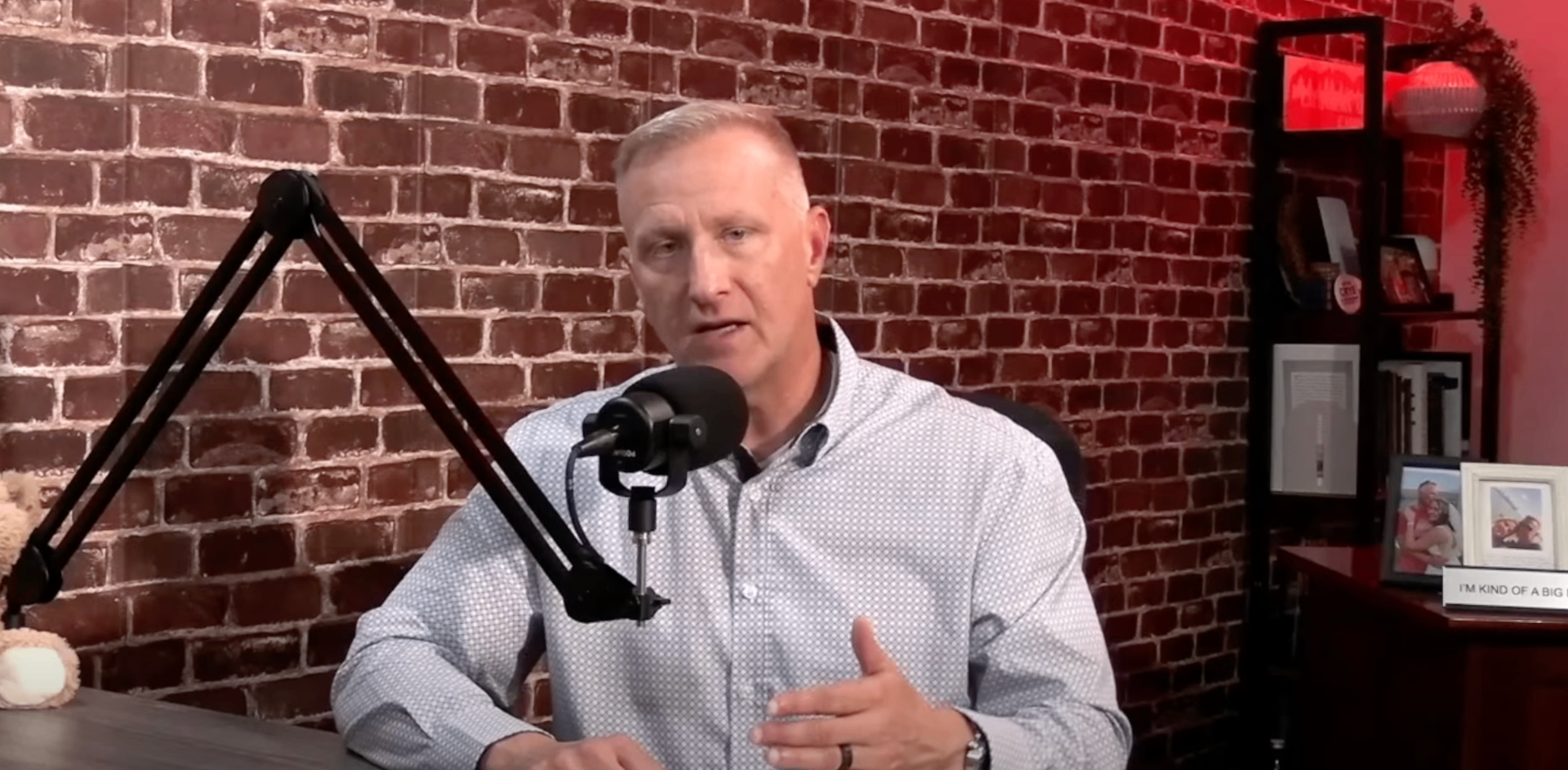 Kevin Crye speaking into a podcast microphone